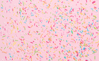 rainbow sprinkles on pink background