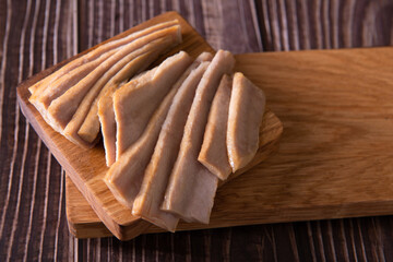 closeup tuna slices on cutting board on wooden background top view