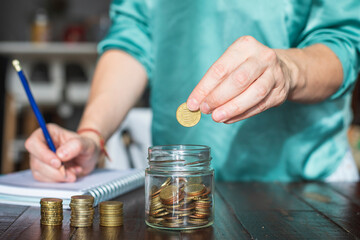 A woman saves money for her future personal projects.
