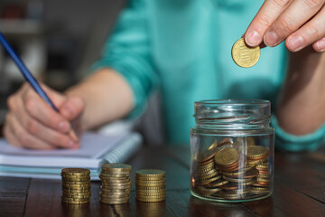 A woman saves money for her future personal projects.
