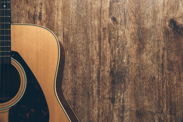 A guitar on a wooden background.