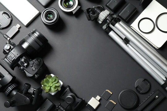 Flat lay composition with camera and video production equipment on black background. Space for text