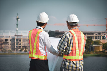 Construction engineer standing in a conversation on the building construction site