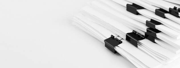 Stack of report paper documents for business desk. Business offices concept, soft focus.