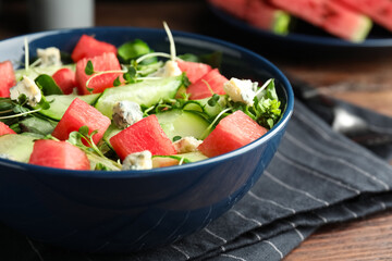 Delicious salad with watermelon served in bowl, closeup