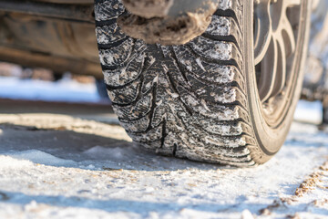 snow and ice winter car tyres. close up auto vehicle wheel