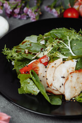 smoked chicken salad on a black plate