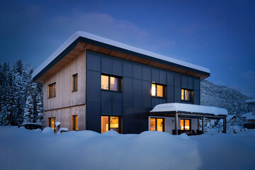 heat energy self-sufficient single-family house in the snow-covered winter with solar thermal...