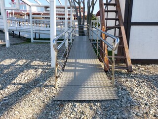 Fototapeta na wymiar Wheelchair access ramp. Entrance to the beach.