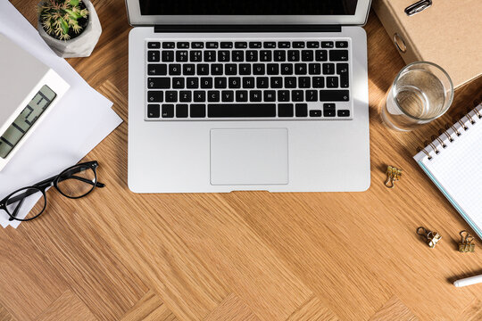 Flat lay composition with laptop and stationery on office table