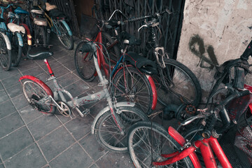 Old bicycles. Several old worn out bicycles on the street.