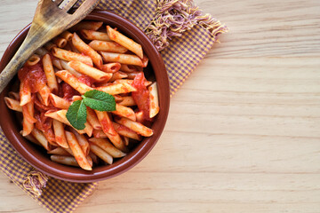 Macaroni and tomato in an earthenware casserole