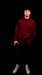 Obraz premium Attractive young man with curly hair posing on black studio background