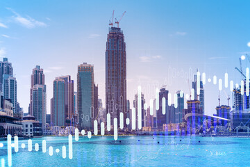 Skyscrapers of Dubai business downtown. International hub of trading and financial services of Western Asia. FOREX graph and chart concept. Double exposure. Dubai Canal waterfront.