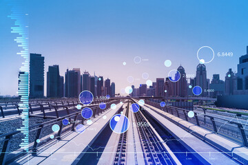 Fototapeta premium The way towards skyscrapers by modern futuristic train. Tech railway delivers commuters to the financial downtown of Dubai. International business hub. Traffic concept. FOREX graph. Double exposure