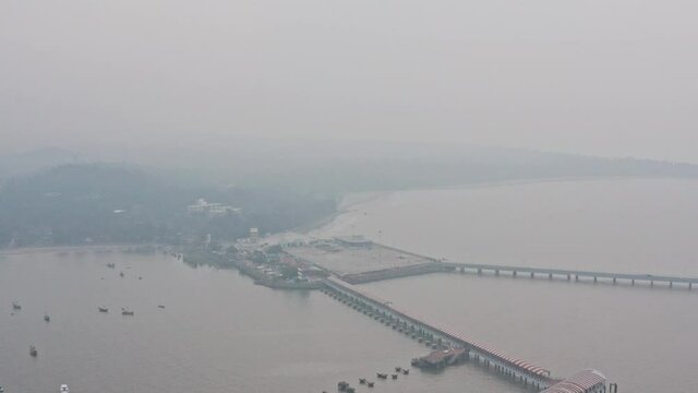 Reveal drone shot of full mandwa jetty on a hazy day