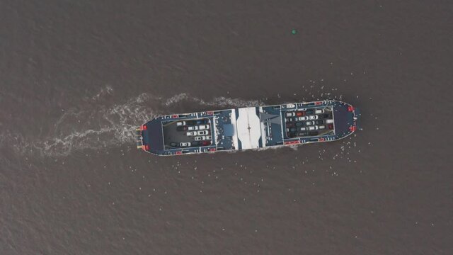 High top down drone shot of car ferry turning India