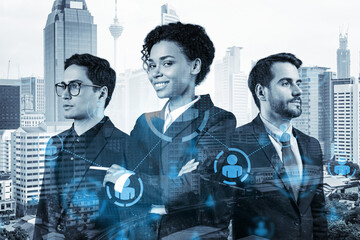 Group of SMM specialists working on social media marketing strategy to achieve business goals. Hologram icons over Kuala Lumpur background.