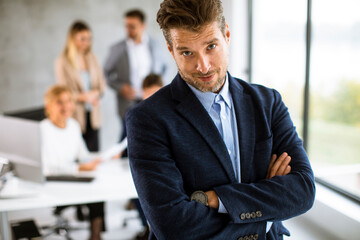 Handsome young business man standing confident in the office