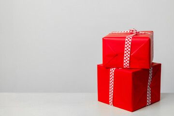 two gift boxes of red color, on a white background. Gift for valentines day, mothers day and christmas. Place for your text. Greeting card