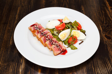 Medium rear beef steak sliced and drizzled with sesame sauce
