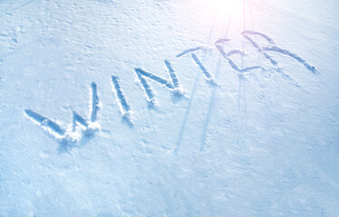 Winter concept. Text Winter written on the snow surface.