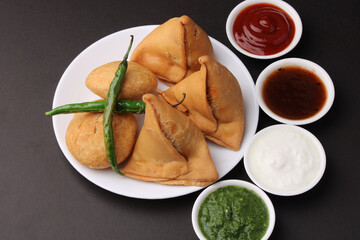 Kachori and samosa, Indian vegetarian snacks served with  green and tamarind chutneys.