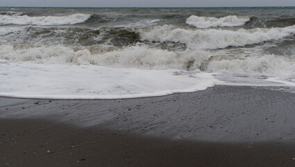 Windy winter conditions creating messy waves on the shoreline.