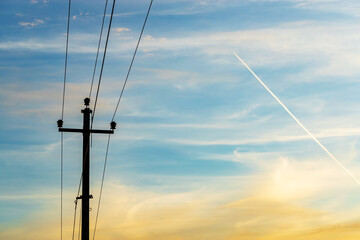 Old concrete electric poles in countryside with the beautiful sky in background.