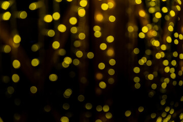 Fototapeta na wymiar Abstract bokeh of yellow lights on black background. Christmas Lights