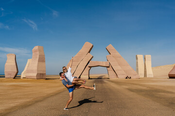 Fototapeta premium Couple jump near huge Gate of Allah, Ras Mohammed national park in Egypt. Desert
