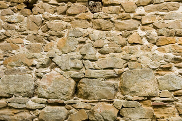 Aged stone wall texture. Textured grunge wall surface background pattern of masonry of old medieval castle