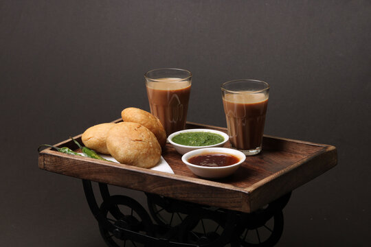 Indian snakes food kachouri or kachoudi kachori served with masala or cutting chai tamarind and mint chutney