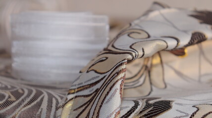 Tape and fabric for curtains close-up. Technological process of sewing curtains.