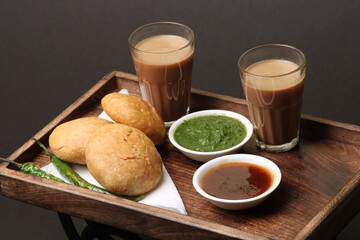 Indian snakes food kachouri or kachoudi kachori served with masala or cutting chai tamarind and mint chutney