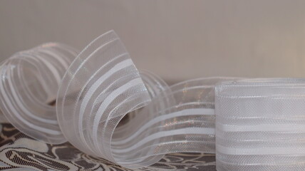 Tape and fabric for curtains close-up. Technological process of sewing curtains.