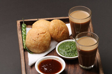 Indian snakes food kachouri or kachoudi kachori served with masala or cutting chai tamarind and mint chutney