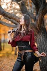 A beautiful girl in a shirt, corset and tight trousers with a saber and a pistol in her hands...