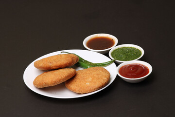 Indian snakes food kachouri or kachoudi kachori served with tamarind and mint chutney