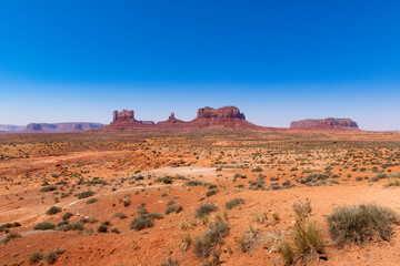 Scenic view of the Monument Valley with the sandstone buttes on a sunny day; Concept for travel in the USA and road trip.