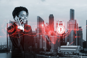 Attractive black businesswoman developer having conference call to protect clients confidential information by inventing solutions. IT lock icons over Singapore city background.