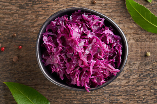 Fermented red cabbage in a bowl on a table, top view