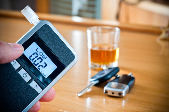 Alcoholic drink, breathalyzer and car keys - do not drink and drive concept