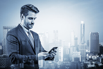 Prosperous European businessman in suit texting phone the details of corporate meeting. Bangkok cityscape. The concept of business communication. Downtown. Double exposure.