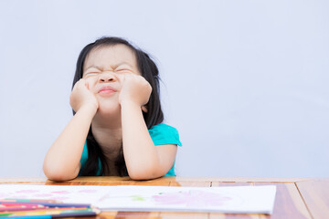 Pupil self isolating herself in doing art homework. Child bored or frustrated and frantic face. Kid...