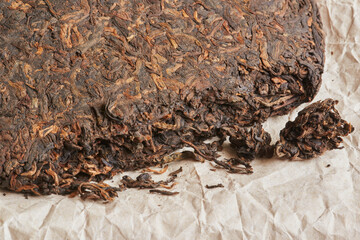 Chinese pressed  pu er tea on wrapping paper  close-up