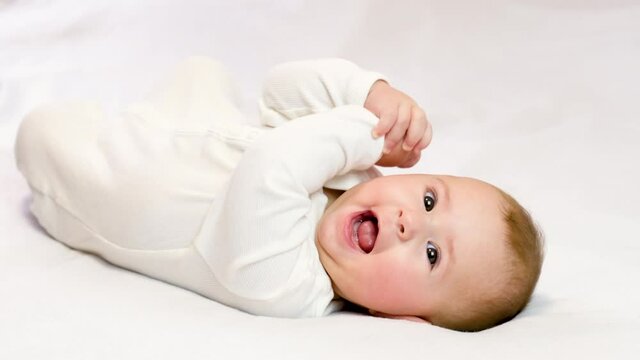 baby on a white background lies smiling. selective focus