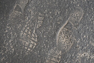 footprints on the pavement etched in cement