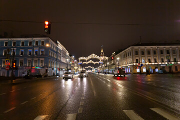 Fototapeta na wymiar Illumination and car traffic on the Nevsky prospect in the late evening.