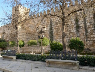Benches in front of medieval wall in Seville, Spain